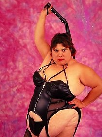 Dominatrix Looking Fat Chick Posing with Whip